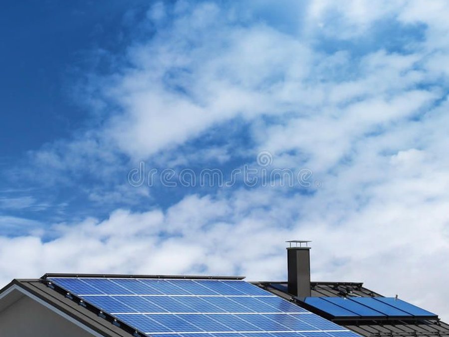 Modern home fitted with sleek solar panels under a blue sky